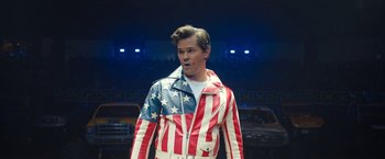 Movie still from “The Prom” (2020), directed by Ryan Murphy – A man wearing a red , white and blue american flag jacket; Medium shot, High angle