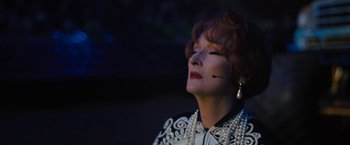 Movie still from “The Prom” (2020), directed by Ryan Murphy – An older woman wearing a white jacket and pearls; Close Up shot, Low angle