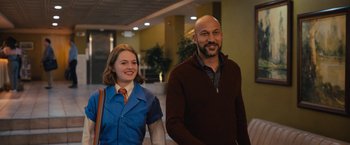 Movie still from “The Prom” (2020), directed by Ryan Murphy – A man and a woman are walking in a hallway; Medium shot, Low angle