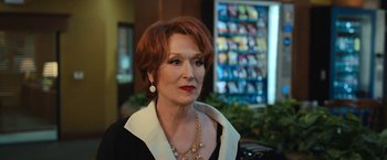 Movie still from “The Prom” (2020), directed by Ryan Murphy – An older woman with red hair wearing a black and white shirt; Close Up shot, Over the shoulder angle