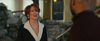 Movie still from “The Prom” (2020), directed by Ryan Murphy – A woman in a black and white dress smiling at the camera; Close Up shot, Over the shoulder angle