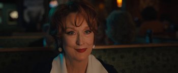 Movie still from “The Prom” (2020), directed by Ryan Murphy – An older woman with red hair and a white shirt; Close Up shot, Over the shoulder angle