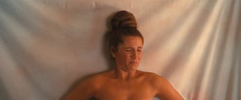 Movie still from “The Prom” (2020), directed by Ryan Murphy – A woman with her eyes closed is laying on a bed; Close Up shot, Overhead angle