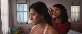 Movie still from “The Prom” (2020), directed by Ryan Murphy – A woman is getting her hair done by another woman; Close Up shot, Over the shoulder angle