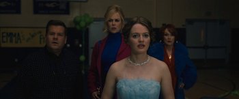Movie still from “The Prom” (2020), directed by Ryan Murphy – A woman in a blue dress standing next to another woman in a blue dress; Close Up shot, Over the shoulder angle