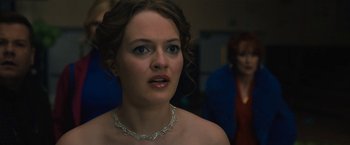 Movie still from “The Prom” (2020), directed by Ryan Murphy – A woman wearing a diamond necklace looking at the camera; Close Up shot, Over the shoulder angle
