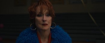Movie still from “The Prom” (2020), directed by Ryan Murphy – An older woman with red hair wearing a blue jacket; Close Up shot, Over the shoulder angle
