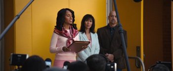 Movie still from “The Prom” (2020), directed by Ryan Murphy – A woman holding a clipboard in front of a crowd; Medium shot, Low angle