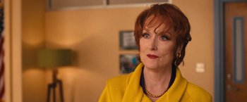 Movie still from “The Prom” (2020), directed by Ryan Murphy – An older woman in a yellow jacket looking at the camera; Close Up shot, Over the shoulder angle