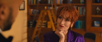 Movie still from “The Prom” (2020), directed by Ryan Murphy – An older woman with red hair is posing for a picture; Close Up shot, Over the shoulder angle