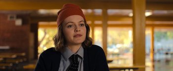 Movie still from “The Prom” (2020), directed by Ryan Murphy – A woman wearing a red hat and a black tie; Close Up shot, Over the shoulder angle