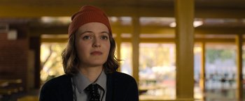 Movie still from “The Prom” (2020), directed by Ryan Murphy – A woman wearing a red hat and a black tie; Close Up shot, Over the shoulder angle