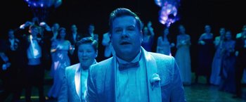 Movie still from “The Prom” (2020), directed by Ryan Murphy – A man and a woman are dressed up for a prom; Medium shot, Over the shoulder angle