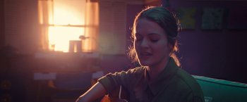 Movie still from “The Prom” (2020), directed by Ryan Murphy – A woman sitting in front of a window with her eyes closed; Close Up shot, Over the shoulder angle