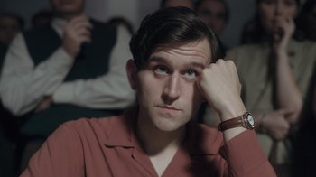 Movie still from “The Queen's Gambit” (2020), directed by Scott Frank – A man with a red shirt is holding his hand up to his face; Close Up shot, Low angle
