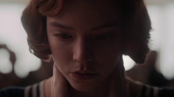 Movie still from “The Queen's Gambit” (2020), directed by Scott Frank – A woman's face in the dark; Close Up shot, Low angle