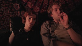 Movie still from “The Queen's Gambit” (2020), directed by Scott Frank – A man and a woman are lying on a bed; Medium shot, Low angle