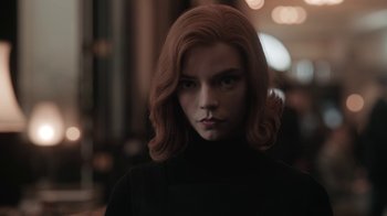 Movie still from “The Queen's Gambit” (2020), directed by Scott Frank – A woman with red hair wearing a black sweater; Close Up shot, Low angle