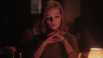 Movie still from “The Queen's Gambit” (2020), directed by Scott Frank – A woman with her hands folded around her neck; Close Up shot, Low angle