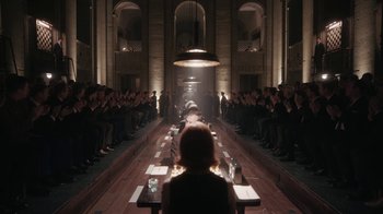 Movie still from “The Queen's Gambit” (2020), directed by Scott Frank – A group of people sitting at a long wooden table; Extreme Wide shot, Over the shoulder angle