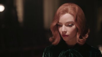 Movie still from “The Queen's Gambit” (2020), directed by Scott Frank – A woman with red hair and a green velvet dress; Close Up shot, High angle