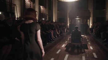 Movie still from “The Queen's Gambit” (2020), directed by Scott Frank – A group of people sitting on a bench in front of a crowd; Wide shot, High angle