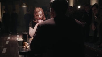 Movie still from “The Queen's Gambit” (2020), directed by Scott Frank – A woman sitting at a table in front of a man; Medium shot, Over the shoulder angle