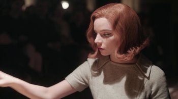 Movie still from “The Queen's Gambit” (2020), directed by Scott Frank – A woman's face with red hair; Close Up shot, Low angle