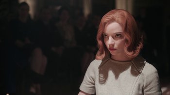 Movie still from “The Queen's Gambit” (2020), directed by Scott Frank – A woman with red curly hair and a white shirt; Close Up shot, Over the shoulder angle