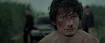 Movie still from “The Raid 2” (2014), directed by Gareth Evans – A person with blood all over his face; Close Up shot, Low angle