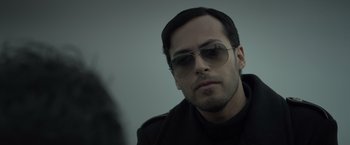 Movie still from “The Raid 2” (2014), directed by Gareth Evans – A person wearing sunglasses; Close Up shot, Low angle