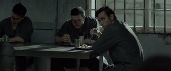 Movie still from “The Raid 2” (2014), directed by Gareth Evans – A couple of men sitting at a table eating food; Medium shot, Over the shoulder angle