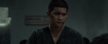 Movie still from “The Raid 2” (2014), directed by Gareth Evans – A person with a bruise on his face; Close Up shot, Over the shoulder angle