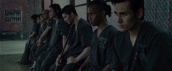 Movie still from “The Raid 2” (2014), directed by Gareth Evans – A group of young men sitting next to each other; Medium shot, High angle