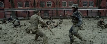 Movie still from “The Raid 2” (2014), directed by Gareth Evans – A group of men are fighting in the mud; Wide shot, High angle