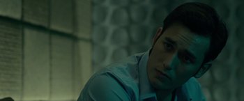 Movie still from “The Raid 2” (2014), directed by Gareth Evans – A man in a white dress shirt is looking at the camera; Close Up shot, Over the shoulder angle