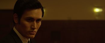 Movie still from “The Raid 2” (2014), directed by Gareth Evans – A person wearing a black shirt; Close Up shot, Low angle