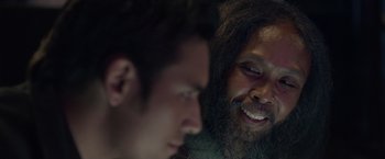 Movie still from “The Raid 2” (2014), directed by Gareth Evans – A man with long hair and a beard is looking at another man's face; Close Up shot, Over the shoulder angle