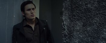 Movie still from “The Raid 2” (2014), directed by Gareth Evans – A man standing in front of a stone wall; Close Up shot, Low angle