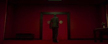 Movie still from “The Raid 2” (2014), directed by Gareth Evans – A man standing in front of an open door; Wide shot, Low angle