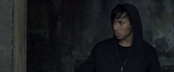 Movie still from “The Raid 2” (2014), directed by Gareth Evans – A man in a black jacket is looking to his left; Close Up shot, High angle