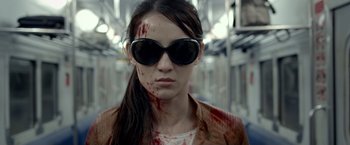 Movie still from “The Raid 2” (2014), directed by Gareth Evans – A woman with blood all over her face and sunglasses; Close Up shot, Over the shoulder angle
