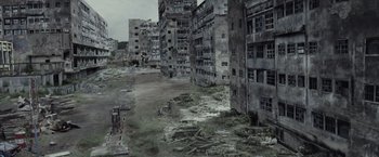 Movie still from “The Raid 2” (2014), directed by Gareth Evans – An abandoned city with many buildings and a lot of debris; Extreme Wide shot, High angle