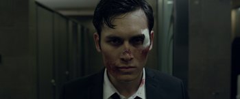 Movie still from “The Raid 2” (2014), directed by Gareth Evans – A man with a bandage on his face; Close Up shot, Low angle