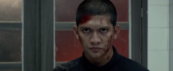 Movie still from “The Raid 2” (2014), directed by Gareth Evans – A man with blood on his face and forehead; Close Up shot, Over the shoulder angle