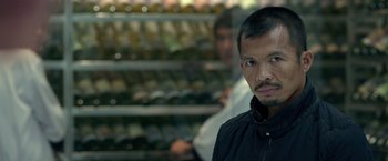 Movie still from “The Raid 2” (2014), directed by Gareth Evans – A person wearing a black jacket; Close Up shot, Over the shoulder angle