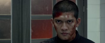 Movie still from “The Raid 2” (2014), directed by Gareth Evans – A man with blood on his face and forehead; Close Up shot, Low angle