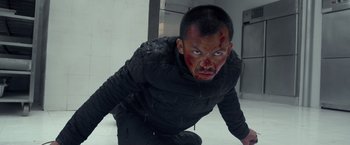 Movie still from “The Raid 2” (2014), directed by Gareth Evans – A man with blood all over his face and head; Medium shot, High angle