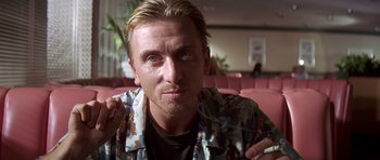 Movie still from “Pulp Fiction” (1994), directed by Quentin Tarantino – A person wearing a shirt; Close Up shot, Over the shoulder angle