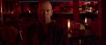 Movie still from “Pulp Fiction” (1994), directed by Quentin Tarantino – A bald man in a brown jacket is in a bar; Close Up shot, Low angle